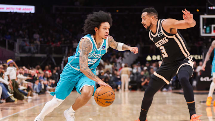 Feb 7, 2026; Atlanta, Georgia, USA; Charlotte Hornets guard Tre Mann (23) drives on Atlanta Hawks guard CJ McCollum (3) in the fourth quarter at State Farm Arena. Mandatory Credit: Brett Davis-Imagn Images