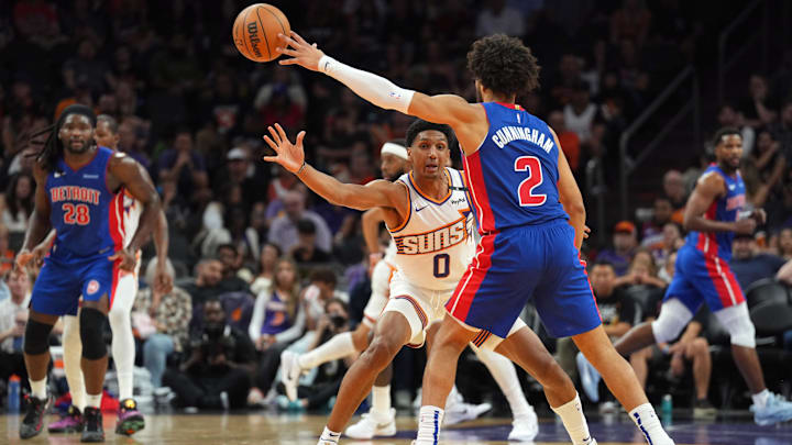 Oct 11, 2024; Phoenix, Arizona, USA; Phoenix Suns forward Ryan Dunn (0) guards Detroit Pistons guard Cade Cunningham (2) during the first half at Footprint Center. Mandatory Credit: Joe Camporeale-Imagn Images