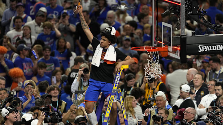 Apr 7, 2025; San Antonio, TX, USA; Florida Gators guard Isaiah Brown (20) cuts the net after defeating the Houston Cougars in the national championship game of the Final Four of the 2025 NCAA Tournament at the Alamodome.Mandatory Credit: Scott Wachter-Imagn Images