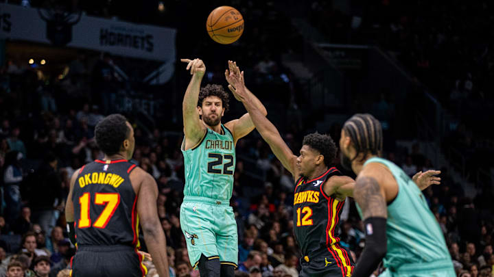 Nov 30, 2024; Charlotte, North Carolina, USA; Charlotte Hornets guard Vasilije Micic (22) passes the ball to center Nick Richards (4) against the Atlanta Hawks during the third quarter at Spectrum Center. Mandatory Credit: Scott Kinser-Imagn Images Nov 30, 2024; Charlotte, North Carolina, USA; Charlotte Hornets guard Vasilije Micic (22) passes the ball to center Nick Richards (4) against the Atlanta Hawks during the third quarter at Spectrum Center. Mandatory Credit: Scott Kinser-Imagn Images