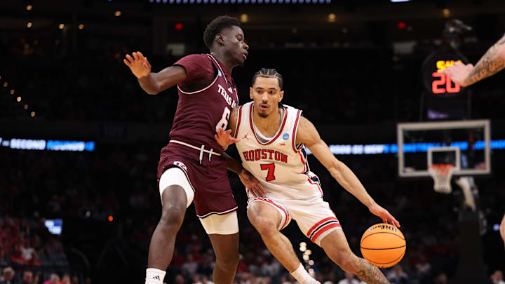 Houston Cougars guard Milos Uzan drives to the hoop past Texas A&M Aggies guard Ali Dibba during the first half of a second-round game of the men's 2026 NCAA Tournament at Paycom Center.