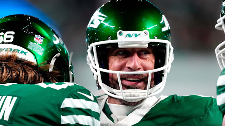 New York Jets quarterback Aaron Rodgers (8) smiles after throwing his fourth touchdown pass of the day, Sunday January 5, 2025, in East Rutherford.