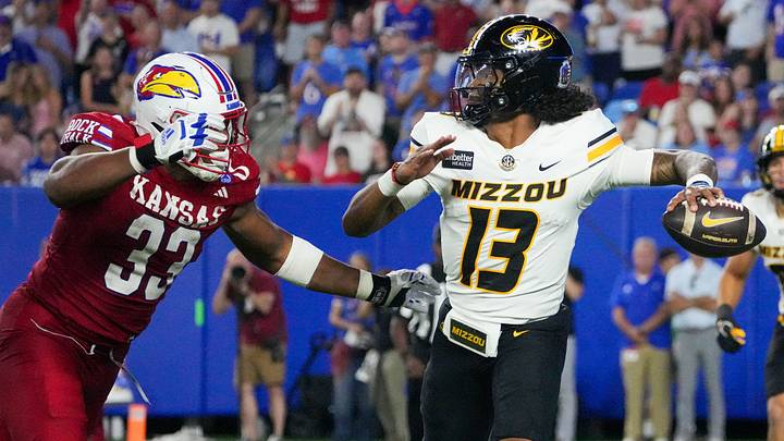Sep 11, 2026; Lawrence, Kansas, USA; Missouri Tigers quarterback Austin Simmons (13) throws a pass as Kansas Jayhawks defensive end Leroy Harris III (33) defends during the second half of the game at David Booth Kansas Memorial Stadium. Mandatory Credit: Denny Medley-Imagn Images Sep 11, 2026; Lawrence, Kansas, USA; Missouri Tigers quarterback Austin Simmons (13) throws a pass as Kansas Jayhawks defensive end Leroy Harris III (33) defends during the second half of the game at David Booth Kansas Memorial Stadium. Mandatory Credit: Denny Medley-Imagn Images