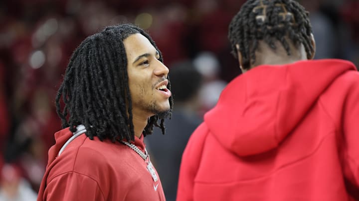 Mar 8, 2025; Fayetteville, Arkansas, USA; Arkansas Razorbacks guard Boogie Fland talks to forward Adou Thiero prior to the game against the Mississippi State Bulldogs at Bud Walton Arena. Mandatory Credit: Nelson Chenault-Imagn Images