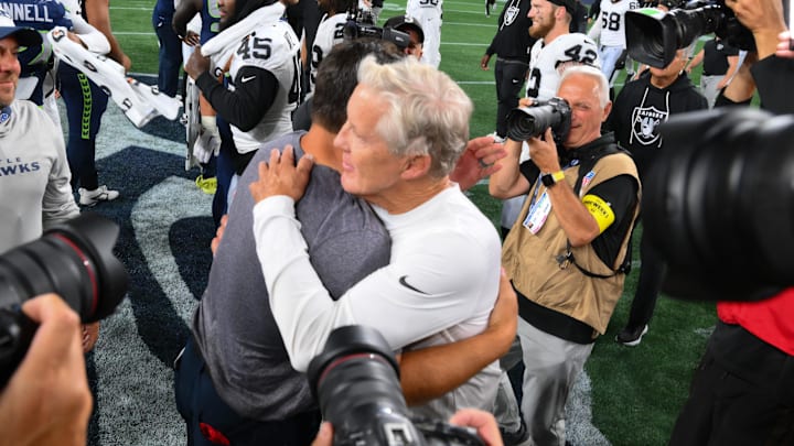 Aug 7, 2025; Seattle, Washington, USA; Las Vegas Raiders head coach Pete Carroll and Seattle Seahawks head coach Mike Macdonald hug after the game at Lumen Field. Mandatory Credit: Steven Bisig-Imagn Images