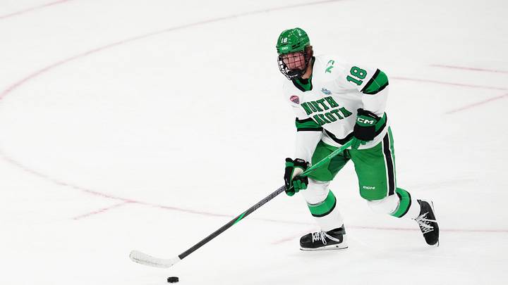 Apr 9, 2026; Las Vegas, Nevada, UNITED STATES;  North Dakota Fighting Hawks defenseman Keaton Verhoeff (18) moves the puck in the first period against the Wisconsin Badgers  in the semifinals of the NCAA men's ice hockey Frozen Four at T-Mobile Arena. Mandatory Credit: Stephen R. Sylvanie-Imagn Images