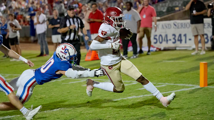 Oct 27, 2023; Metairie, LA, USA; Brother Martin Crusaders wide receiver Easton Royal (23) scores a touchdown against John Curtis Patriots linebacker Benjamin Barron (30) during the first quarter at The Shrine on Airline. Mandatory Credit: Matthew Hinton-Imagn Images Oct 27, 2023; Metairie, LA, USA; Brother Martin Crusaders wide receiver Easton Royal (23) scores a touchdown against John Curtis Patriots linebacker Benjamin Barron (30) during the first quarter at The Shrine on Airline. Mandatory Credit: Matthew Hinton-Imagn Images