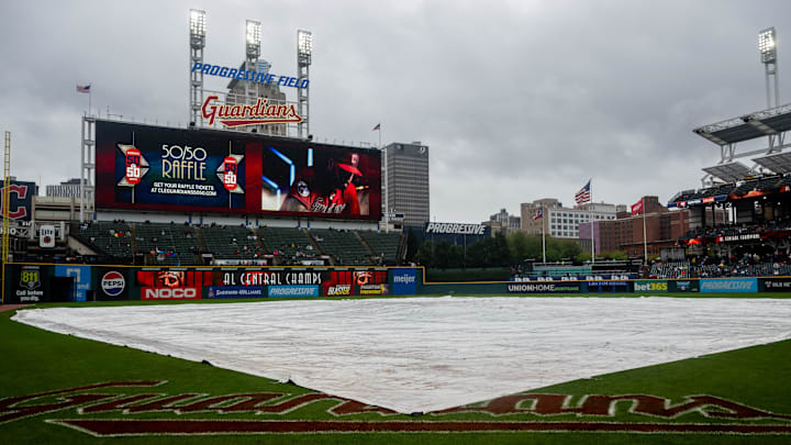 Sep 29, 2024; Cleveland, Ohio, USA; The tarp covers the field as the game between the Cleveland Guardians and the Houston Astros is delayed at Progressive Field. Mandatory Credit: Ken Blaze-Imagn Images