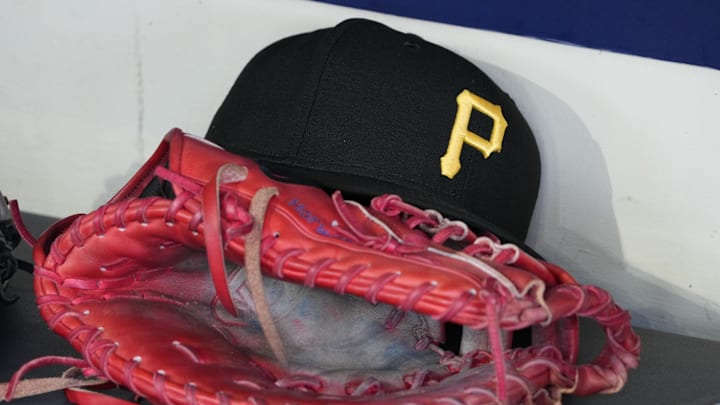 Jun 23, 2025; Milwaukee, Wisconsin, USA; against the Pittsburgh Pirates hat and glove in the dugout before a game against the Milwaukee Brewers at American Family Field. Mandatory Credit: Michael McLoone-Imagn Images