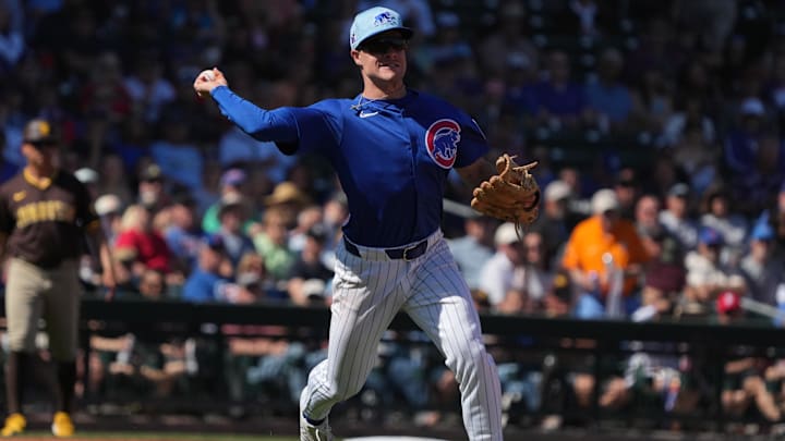 Mar 4, 2025; Mesa, Arizona, USA; Chicago Cubs third baseman Matt Shaw makes the off balance throw for an out against the San Diego Padres in the third inning at Sloan Park. Mar 4, 2025; Mesa, Arizona, USA; Chicago Cubs third baseman Matt Shaw makes the off balance throw for an out against the San Diego Padres in the third inning at Sloan Park.