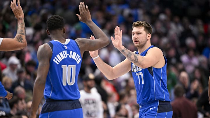 Nov 18, 2022; Dallas, Texas, USA; Dallas Mavericks forward Dorian Finney-Smith (10) and guard Luka Doncic (77) in action during the game between the Dallas Mavericks and the Denver Nuggets at the American Airlines Center. Mandatory Credit: Jerome Miron-Imagn Images