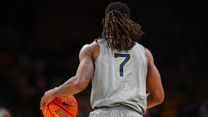 Jan 12, 2025; Boulder, Colorado, USA; West Virginia Mountaineers guard Javon Small (7) controls the ball in the second half against the Colorado Buffaloes at CU Events Center. Mandatory Credit: Ron Chenoy-Imagn Images