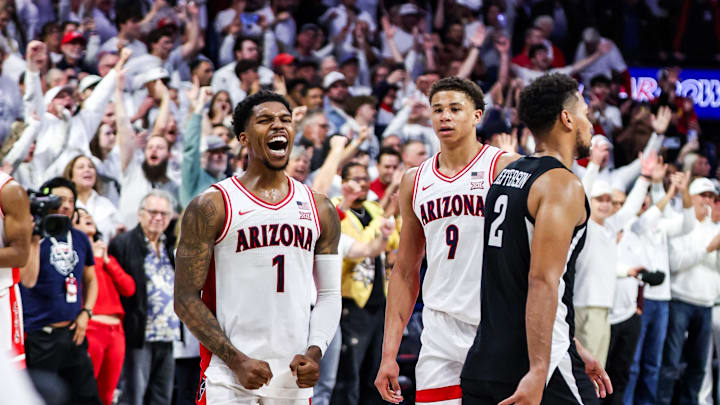 Arizona Wildcats guard Caleb Love (1) celebrates the win while Iowa State Cyclones forward Joshua Jefferson (2) leaves the court at the end of overtime at McKale Center. 