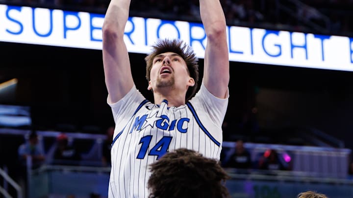 Oct 12, 2025; Orlando, Florida, USA; Orlando Magic center Colin Castleton (14) makes a layup over Miami Heat guard Pelle Larsson (9) and Miami Heat guard Ethan Thompson (55) during the second half at Kia Center. Mandatory Credit: Matt Pendleton-Imagn Images Oct 12, 2025; Orlando, Florida, USA; Orlando Magic center Colin Castleton (14) makes a layup over Miami Heat guard Pelle Larsson (9) and Miami Heat guard Ethan Thompson (55) during the second half at Kia Center. Mandatory Credit: Matt Pendleton-Imagn Images