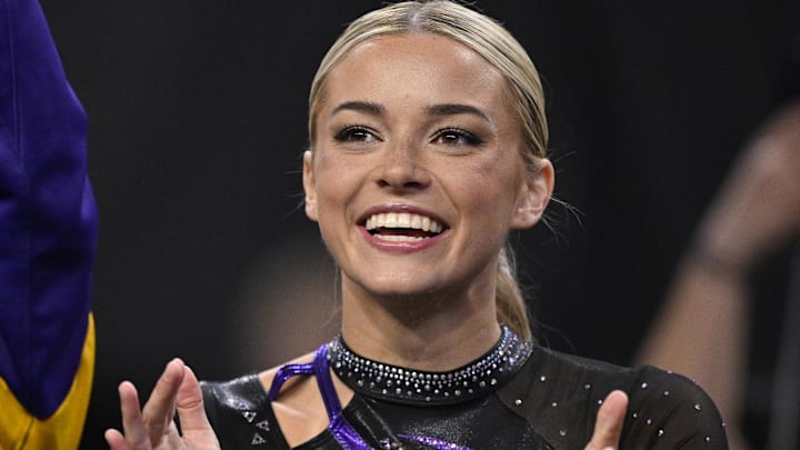 Apr 17, 2025; Fort Worth, TX, USA; LSU Tigers gymnast Olivia Dunne cheers for the LSU gymnastic team during the 2025 Women's National Gymnastics Semifinal at Dickies Arena.