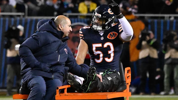 T.J. Edwards waves to the crowd and his team after he suffered a broken leg in the playoff win over Green Bay.