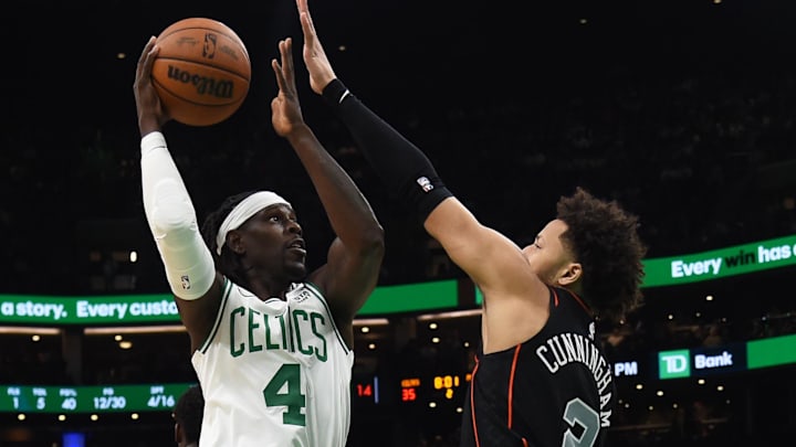 Dec 28, 2023; Boston, Massachusetts, USA;  Boston Celtics guard Jrue Holiday (4) shoots the ball while Detroit Pistons guard Cade Cunningham (2) defends during the first half at TD Garden. Mandatory Credit: Bob DeChiara-Imagn Images