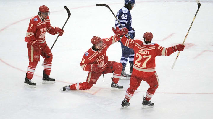Jan 1, 2014; Ann Arbor, MI, USA; Detroit Red Wings left wing Justin Abdelkader (8) celebrates with Kyle Quincey (27). 