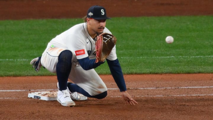 Oct 16, 2025; Seattle, Washington, USA; Seattle Mariners first baseman Josh Naylor (12) makes a force out in the fifth inning against the Toronto Blue Jays during game four of the ALCS round for the 2025 MLB playoffs at T-Mobile Park. Mandatory Credit: Steven Bisig-Imagn Images