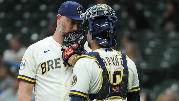 Aug 2, 2021; Milwaukee, Wisconsin, USA;  Milwaukee Brewers John Axford (59) talks with catcher Omar