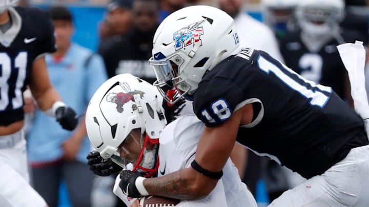 Liberty quarterback Kaidon Salter (7) runs the option as he is stopped by Middle Tennessee safety Xavier Williams (18) during the Salute to Veterans & Armed Forces game at MTSU on Saturday, Nov. 9, 2024.