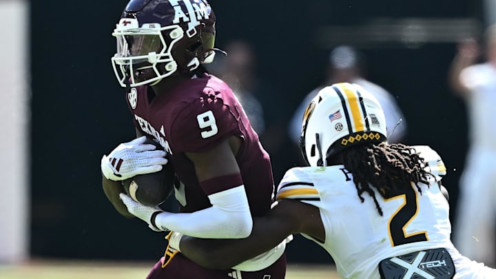 Oct 5, 2024; College Station, Texas, USA; Texas A&M Aggies defensive back Trey Jones III (9) runs the ball as Missouri Tigers cornerback Toriano Pride Jr. (2) defends in the first half against the Texas A&M Aggies at Kyle Field. Mandatory Credit: Maria Lysaker-Imagn Images. 