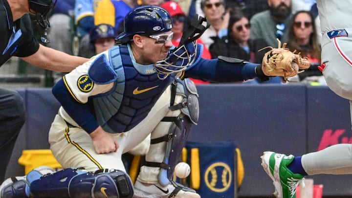 Sep 4, 2025; Milwaukee, Wisconsin, USA;  Milwaukee Brewers catcher Danny Jansen (33) loses his facemask after getting hit by a foul ball against the Philadelphia Phillies in the eighth inning at American Family Field. Mandatory Credit: Benny Sieu-Imagn Images