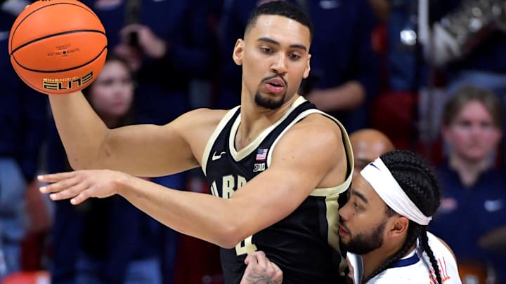 Mar 7, 2025; Champaign, Illinois, USA;  Illinois Fighting Illini guard Kylan Boswell (4) guards Purdue Boilermakers forward Trey Kaufman-Renn (4) during the first half at State Farm Center. Mandatory Credit: Ron Johnson-Imagn Images