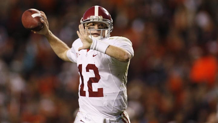 Nov 27, 2009; Auburn, AL, USA; Alabama quarterback Greg McElroy (12) scrambles out of the pocket to pass against the Auburn Tigers during the 4th quarter of the 74th annual iron bowl at Jordan-Hare Stadium. Alabama defeated Auburn 26-21.  Mandatory Credit: John David Mercer-Imagn Images