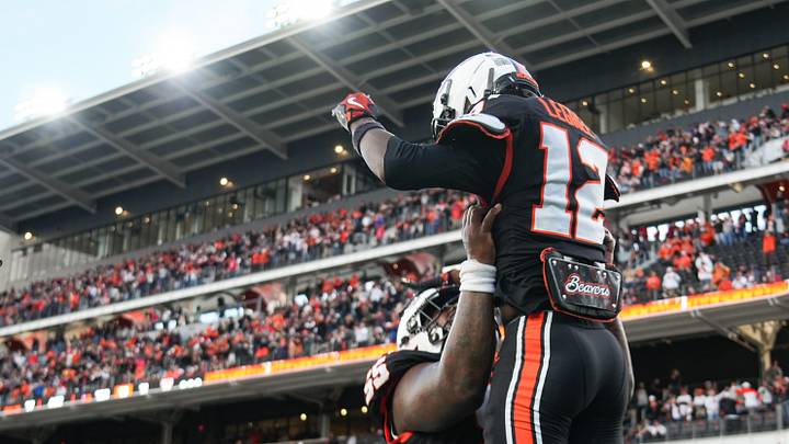 Oregon State's Jesse Legree, right, gets carried by teammate Jeremiah Ioane after scoring a touchdown during an NCAA football game at Reser Stadium on Sept. 12 in Corvallis.
