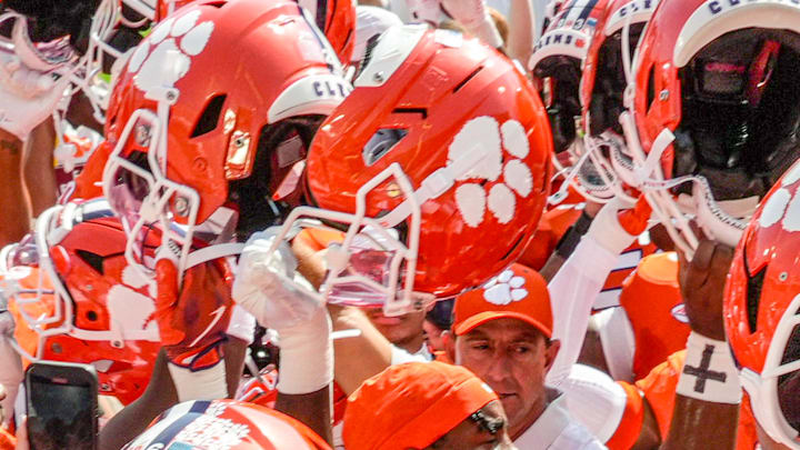 Sep 20, 2025; Clemson, South Carolina, USA; Clemson Tigers head coach Dabo Swinney in a huddle with players during pregame practice before their game against the Syracuse Orange in Memorial Stadium. Mandatory Credit: Ken  Ruinard/GREENVILLE NEWS-USA TODAY Network via Imagn Images