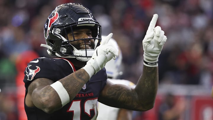Houston Texans wide receiver Nico Collins (12) reacts to a first down against the Los Angeles Chargers in the second quarter in an AFC wild card game at NRG Stadium. 