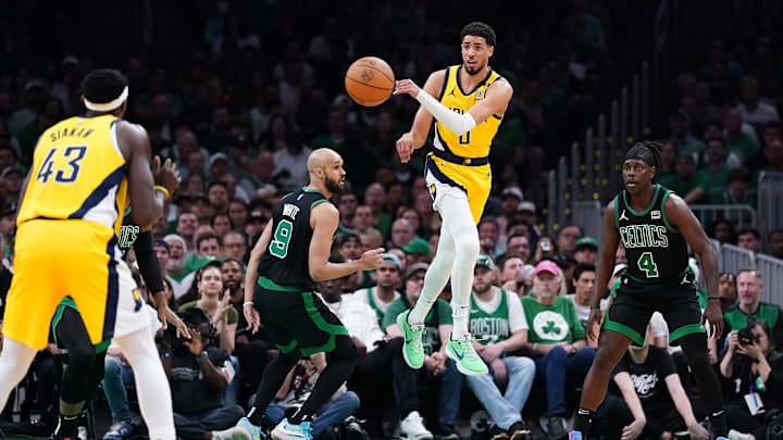 May 23, 2024; Boston, Massachusetts, USA; Indiana Pacers guard Tyrese Haliburton (0) passes the ball against Boston Celtics guard Derrick White (9) in the first half during game two of the eastern conference finals for the 2024 NBA playoffs at TD Garden. Mandatory Credit: David Butler II-USA TODAY Sports
