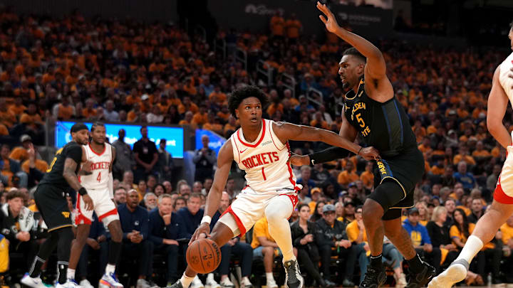 May 2, 2025; San Francisco, California, USA; Houston Rockets forward Amen Thompson (1) dribbles the ball next to Golden State Warriors forward Kevon Looney (5) in the second quarter of game six of the first round for the 2025 NBA Playoffs at Chase Center. Mandatory Credit: Cary Edmondson-Imagn Images