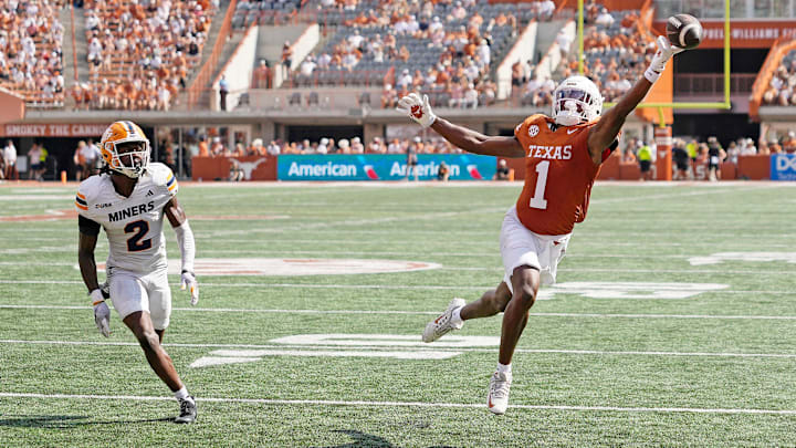 Sep 13, 2025; Austin, Texas, USA; Texas Longhorns wide receiver Ryan Wingo (1) reaches for a pass while defended by Texas El Paso Miners safety Xavier Smith (2) during the first half at Darrell K Royal-Texas Memorial Stadium. Mandatory Credit: Scott Wachter-Imagn Images