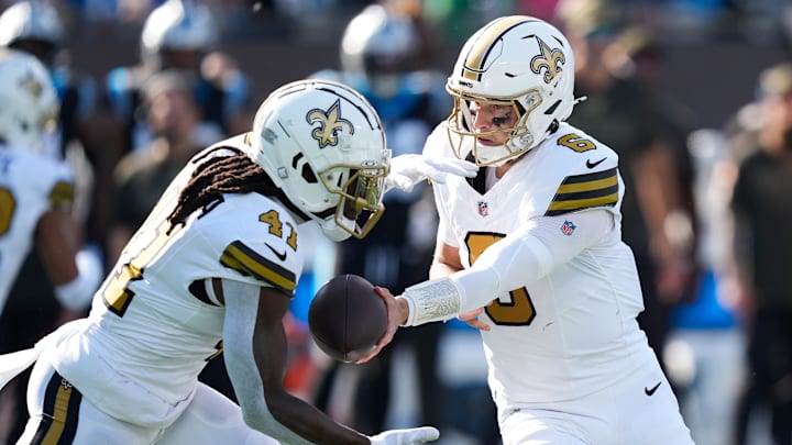 Nov 9, 2025; Charlotte, North Carolina, USA; New Orleans Saints quarterback Tyler Shough (6) hands the ball off to New Orleans Saints running back Alvin Kamara (41) during the second quarter against the Carolina Panthers at Bank of America Stadium. Mandatory Credit: Jim Dedmon-Imagn Images