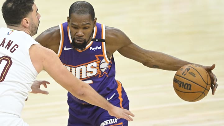 Jan 20, 2025; Cleveland, Ohio, USA; Phoenix Suns forward Kevin Durant (35) dribbles beside Cleveland Cavaliers forward Georges Niang (20) in the third quarter at Rocket Mortgage FieldHouse. Mandatory Credit: David Richard-Imagn Images