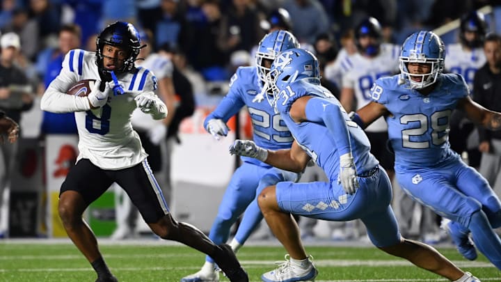 Nov 11, 2023; Chapel Hill, North Carolina, USA; Duke Blue Devils wide receiver Jordan Moore (8) with the ball as North Carolina Tar Heels defensive backs Marcus Allen (29) and  Alijah Huzzie (28) and Will Hardy (31) defend in the second quarter at Kenan Memorial Stadium. Mandatory Credit: Bob Donnan-Imagn Images