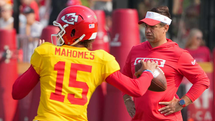Jul 26, 2024; Kansas City, MO, USA; Kansas City Chiefs quarterback Patrick Mahomes (15) throws a pass as general manager Brett Veach watches in the background during training camp at Missouri Western State University. Mandatory Credit: Denny Medley-Imagn Images