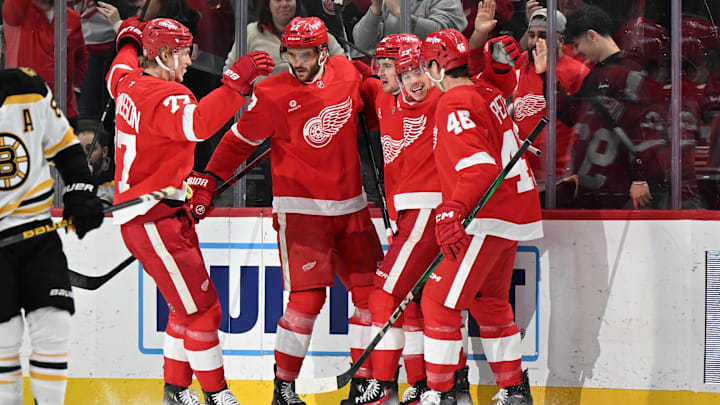 Mar 29, 2025; Detroit, Michigan, USA;  Detroit Red Wings center Marco Kasper (92) celebrates with his teammates  defenseman Simon Edvinsson (77) center Michael Rasmussen (27) left wing Lucas Raymond (23) and defenseman Jeff Petry (46) after scoring a goal against the Boston Bruins in the first period at Little Caesars Arena. Mandatory Credit: Lon Horwedel-Imagn Images