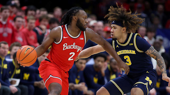 Feb 16, 2025; Columbus, Ohio, USA;  Ohio State Buckeyes guard Bruce Thornton (2) dribbles the ball as Michigan Wolverines guard Tre Donaldson (3) defends during the first half at Value City Arena. Mandatory Credit: Joseph Maiorana-Imagn Images