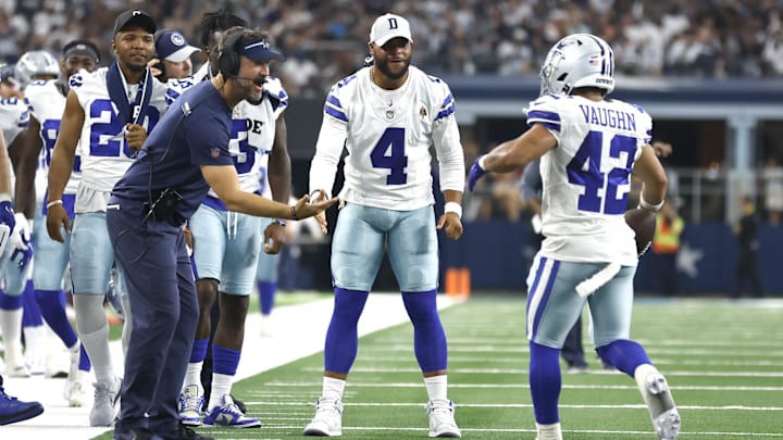  Dallas Cowboys' Brian Schottenheimer, Dak Prescott, and Deuce Vaughn celebrate a touchdown against the Jacksonville Jaguars.