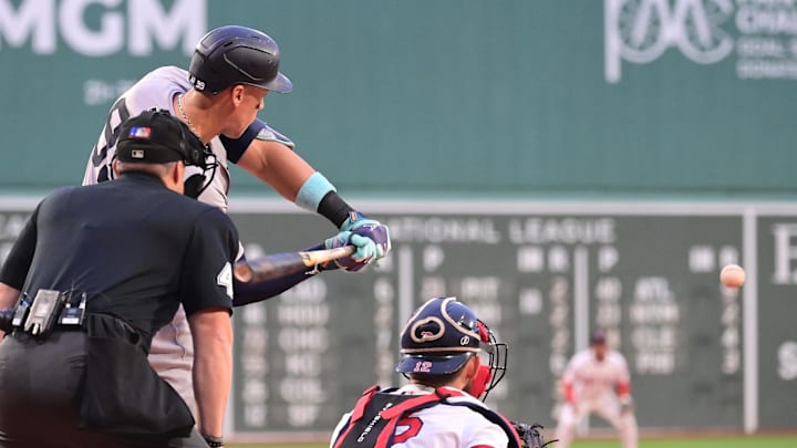 Jul 28, 2024; Boston, Massachusetts, USA; New York Yankees designated hitter Aaron Judge (99) hits an RBI single during the first inning against the Boston Red Sox at Fenway Park. Mandatory Credit: Eric Canha-Imagn Images
