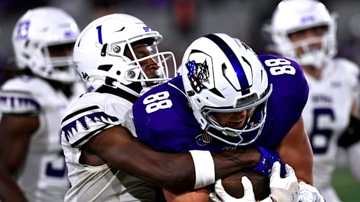 SFA cornerback Charles Demmings tries to pull down ACU tight end Jed Castles Saturday Sept. 6, 2025. Abilene Christian University defeated Stephen F. Austin University at home, 28-20.