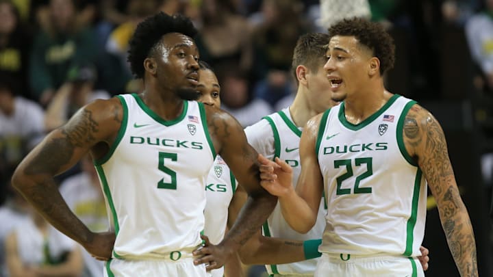 Oregon's Jermaine Couisnard, left, and Jadrian Tracey meet at mid-court during their game.