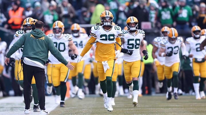 Xavier McKinney (29) leads the Green Bay Packers out before the playoff game at the Philadelphia Eagles.