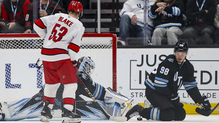 Nov 13, 2024; Salt Lake City, Utah, USA; Utah Hockey Club goaltender Karel Vejmelka (70) deflects the puck from Carolina Hurricanes right wing Jackson Blake (53) during the second period at Delta Center. Mandatory Credit: Rob Gray-Imagn Images