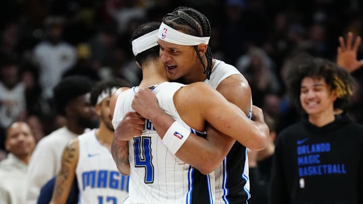 Orlando Magic guard Jalen Suggs (4) and forward Paolo Banchero (5) celebrate defeating the Denver Nuggets at Ball Arena.