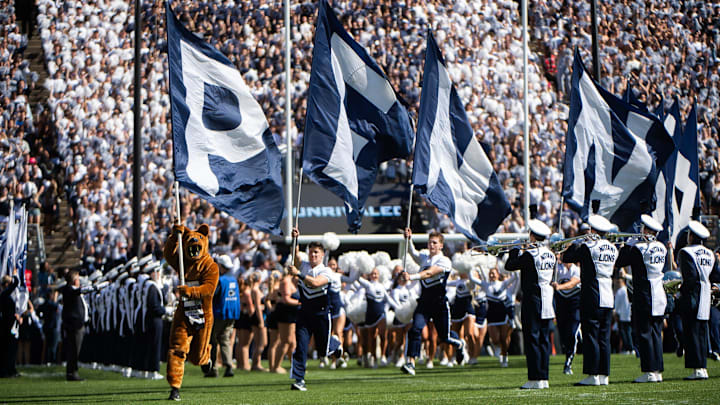The Penn State Nittany Lion mascot leads the way as the Penn State football team takes the field for an NCAA football game against Nevada.