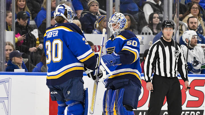 Jan 27, 2025; St. Louis, Missouri, USA;  St. Louis Blues goaltender Jordan Binnington (50) is replaced by goaltender Joel Hofer (30) during the second period against the Vancouver Canucks at Enterprise Center. Mandatory Credit: Jeff Curry-Imagn Images